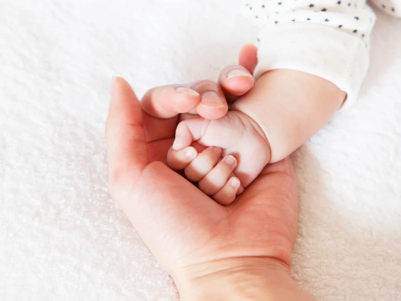 mother holding her baby's hand