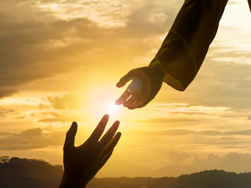 hand reaching out to another hand