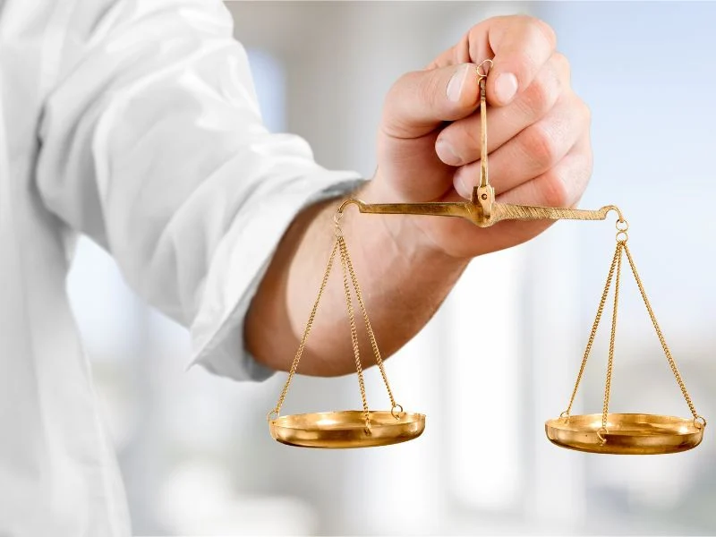 man holding a balanced scale
