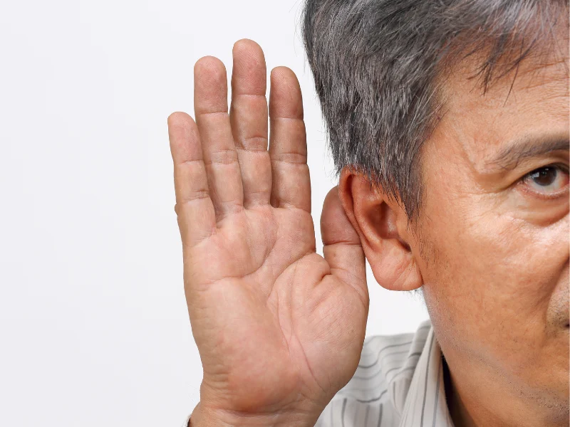 Deaf man holding a hand up to his ear
