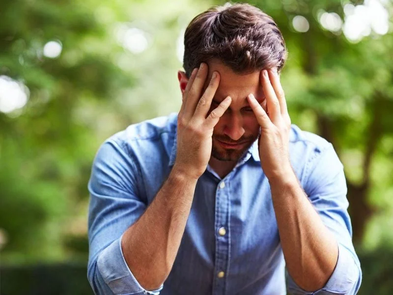 Man holding his face in his hands in disappointment
