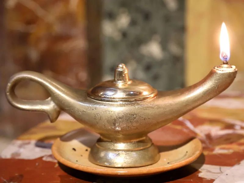 Ancient oil lamp lit with a flame