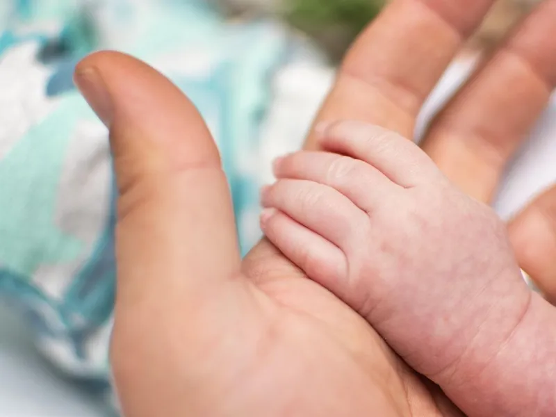 Father holding a babys tiny hand